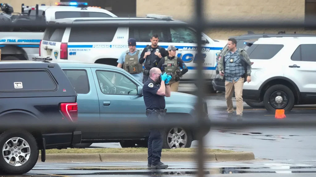 Police investigate as emergency vehicles are parked outside the Abundant Life Christian School in Madison, Wis., where multiple injuries were reported following a shooting, Monday, Dec. 16, 2024