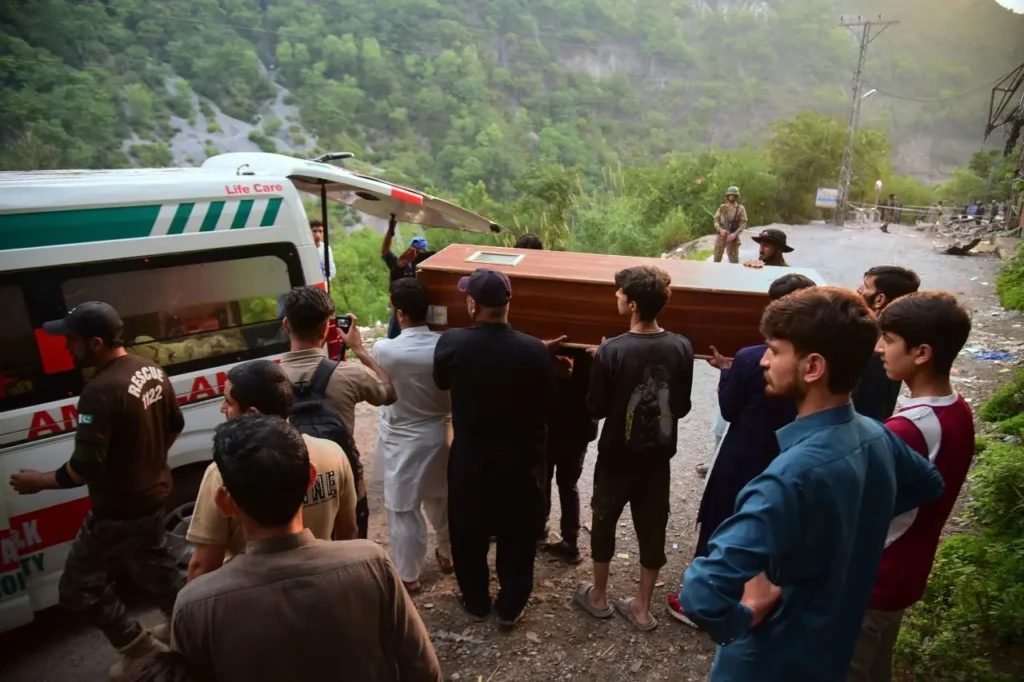 Trendsnip Volunteers carry a body from the rubble of a damaged mosque in Pakistan-administered Kashmir.